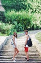 Two young tourists taking a break on old stairway Royalty Free Stock Photo