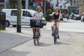 Two young, walking bicycle