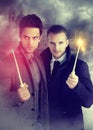 Two young wizards holding a magic wand Royalty Free Stock Photo