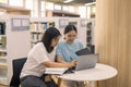 Two young woman, a dedicated student, navigates university life with her friend, embracing education and growth as they pursue Royalty Free Stock Photo