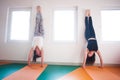 Two young woman doing handstand indoor
