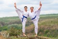 Two young woman doing a synchronised workout