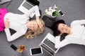 Two young woman relaxing in the office, view from above Royalty Free Stock Photo