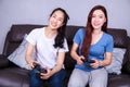 Two young woman using joystick controller playing video game on Royalty Free Stock Photo