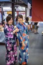 Two young woman wearing japanese traditional kimono enjoy the stroll Royalty Free Stock Photo