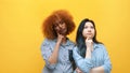 Two young women, asian and african american friends thinking . Problem solving and multiracial work colleagues concept Royalty Free Stock Photo