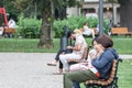 Two young women, Asians, from china, tourists in Serbia, using their smartphones and applications to text using the internet