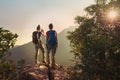 Backpackers enjoy the view on cliff`s edge Royalty Free Stock Photo