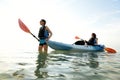 Two young women and blue kayak in Atlantic Ocean