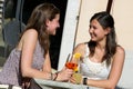 Two Young Women Cheering with Cold Drinks