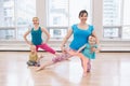 Two young women with children doing workout in gym class to loose baby weight. Royalty Free Stock Photo