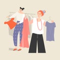 Two young women choose clothes in the store