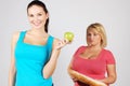 Two young women choosing food for diet