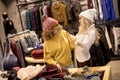 Two young women choosing winter clothes Royalty Free Stock Photo