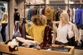 Two young women choosing winter clothes Royalty Free Stock Photo