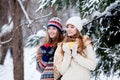 Two young women with colorful cups dring tea outdoor