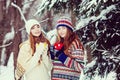 Two young women with colorful cups drinking tea outdoor and smiling Royalty Free Stock Photo