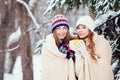 Two young women with colorful cups drinking tea outdoor and smiling Royalty Free Stock Photo