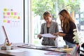 Two women designer brainstorming and working on mobile app interface wireframe design together. Royalty Free Stock Photo