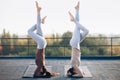 Two young women doing double yoga asana supported headstand Royalty Free Stock Photo