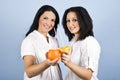 Two young women drinking citrus juice Royalty Free Stock Photo