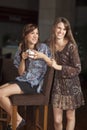 Two young women drinking coffee at a bar Royalty Free Stock Photo