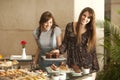 Two young women enjoying a dessert buffet Royalty Free Stock Photo