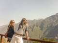 Two Young Women Enjoying The View of Mountains