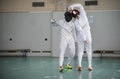 Two young women fencers having a training