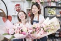 Two young women florist partners giving floral bunch with a happy smile Royalty Free Stock Photo