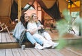 Two young women friends drinking tea and relaxing in glamping in the woods Royalty Free Stock Photo