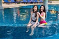 Two young women friends enjoy in swimming pool Royalty Free Stock Photo