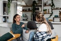 Two young women friends, roommates, business partners and owners of a small business are arguing at home due to the inappropriate