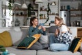 Two young women friends, roommates, business partners and owners of a small business are arguing at home due to the inappropriate Royalty Free Stock Photo