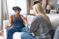 Two young women friends roommates business partners owners of a small business LGBTQ+ lesbian couple arguing at home due to Royalty Free Stock Photo