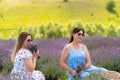 Two young women friends sitting in a field of lavender Royalty Free Stock Photo