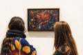 Two young women and George Grosz painting