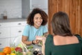 Two young women having breakfast at a table in the kitchen. Royalty Free Stock Photo