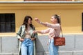 Two young women having fun on city street outdoors - Mixed race female friends enjoying a holiday day out together - Happy Royalty Free Stock Photo