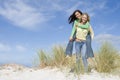 Two young women having fun in dunes Royalty Free Stock Photo