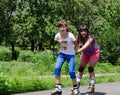 Two young women having fun rollerblading