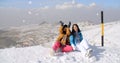 Two young women having fun in winter snow Royalty Free Stock Photo