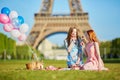 Two young women having picnic near the eiffel tower in Paris, France Royalty Free Stock Photo