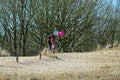 Two young women with helium ballons on a sandy dune