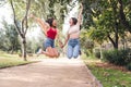 two young women jumping with joy holding hands Royalty Free Stock Photo