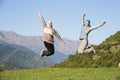 Two young women jumping Royalty Free Stock Photo