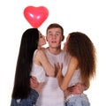 Two young women kissing to the man. Royalty Free Stock Photo