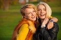 Two young women laughing in the park Royalty Free Stock Photo