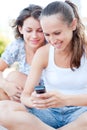 Two young women looking at cellphone