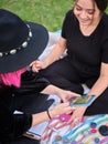 two young women looking at a design to characterize on the phone